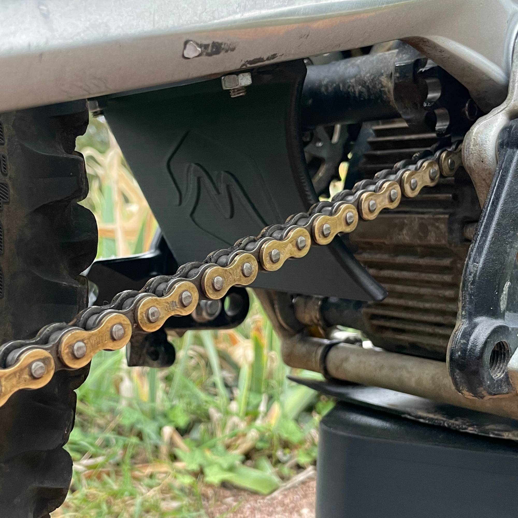 surron lb belt protector on bike chain side